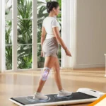 Person walking on the WalkingPad C2, side view showing the cushioned deck