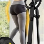 Woman using the OWLSKY elliptical from a rear angle, OWLSKY logo visible on flywheel