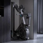 Merach R60N rower folded upright against a wall for vertical storage