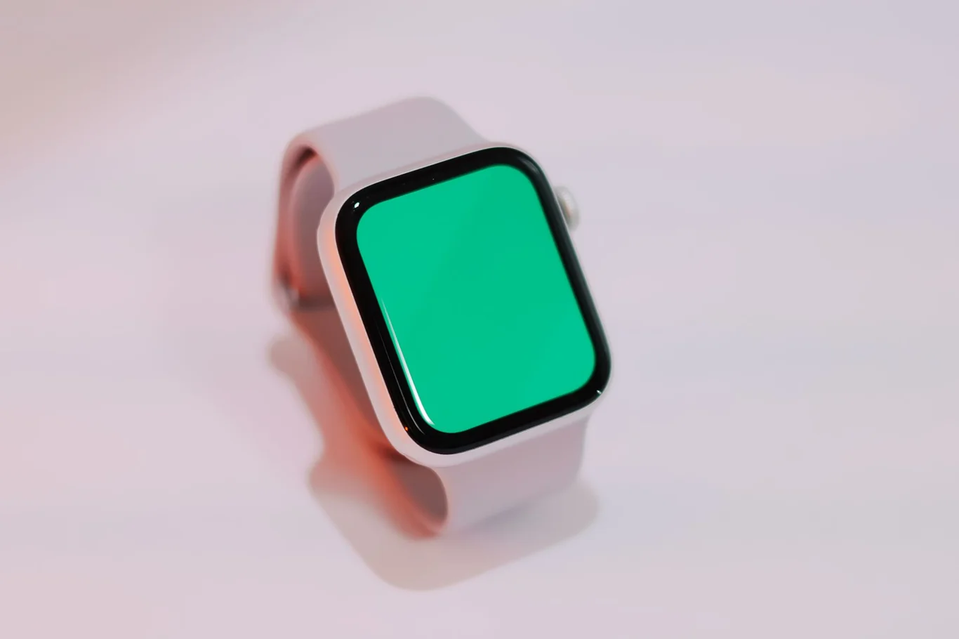 Apple Watch with pink sport band on a light studio background