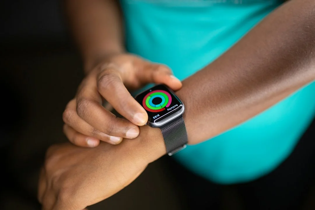 Athlete checking Apple Watch activity rings during a workout