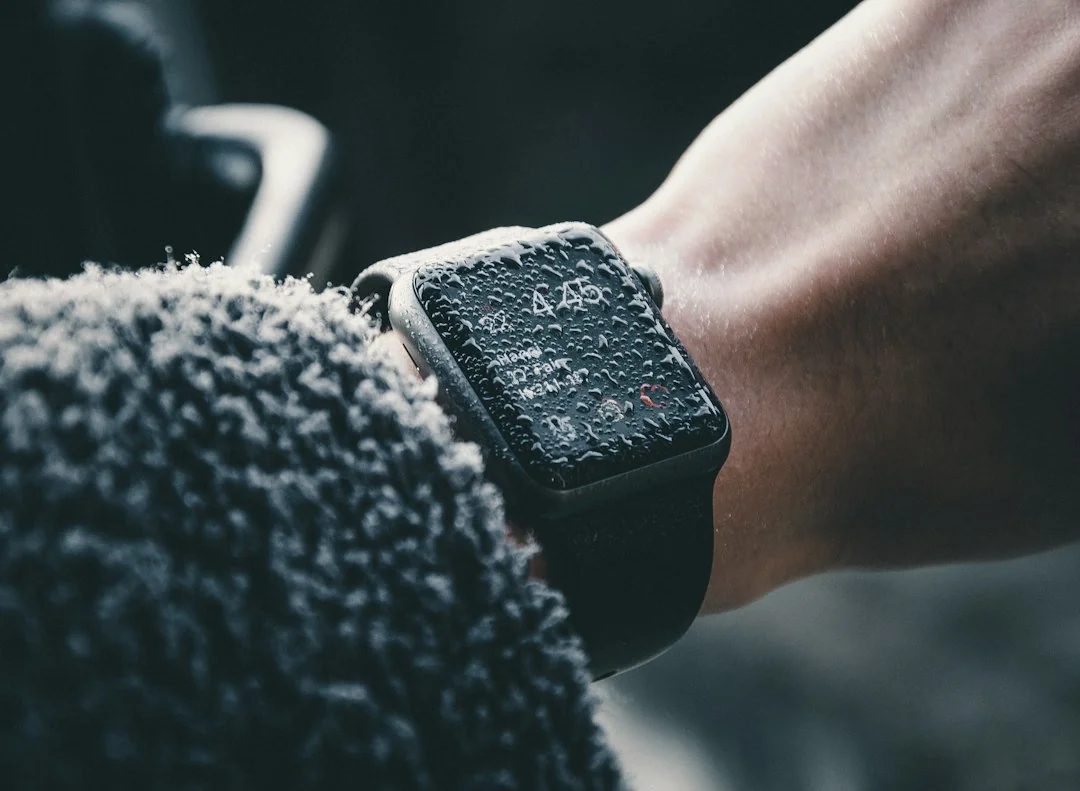 Apple Watch on a wrist resting against a soft dark surface