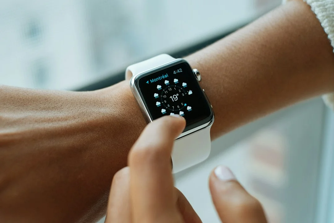 Person tapping an Apple Watch on their wrist to check health data
