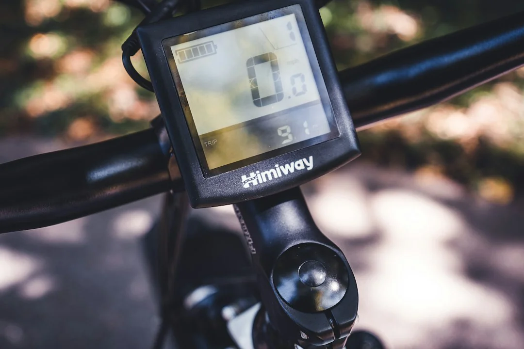 Close-up of a digital display screen mounted on bicycle handlebars showing workout metrics