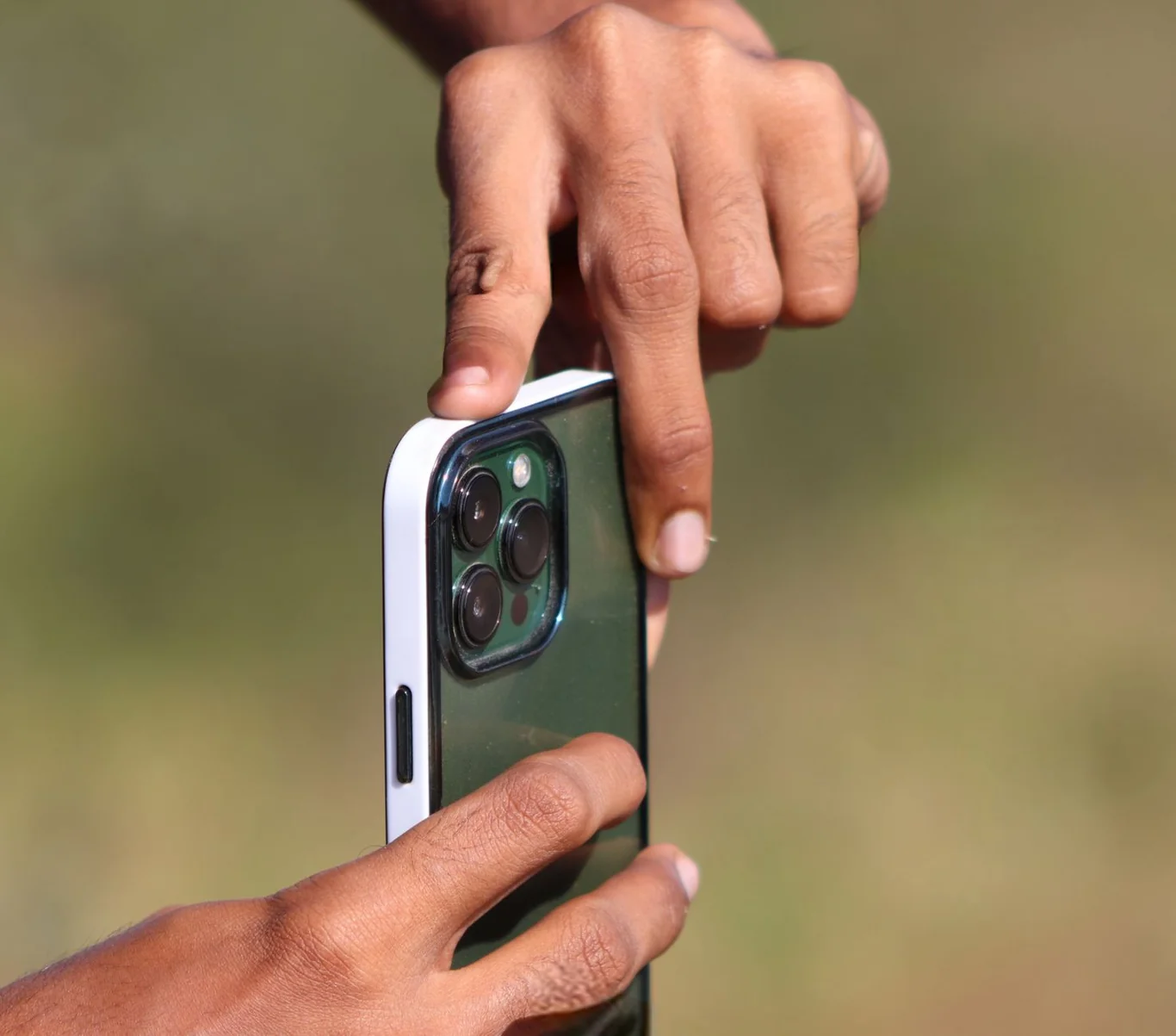 Person pressing finger on rear camera of an iPhone to measure heart rate