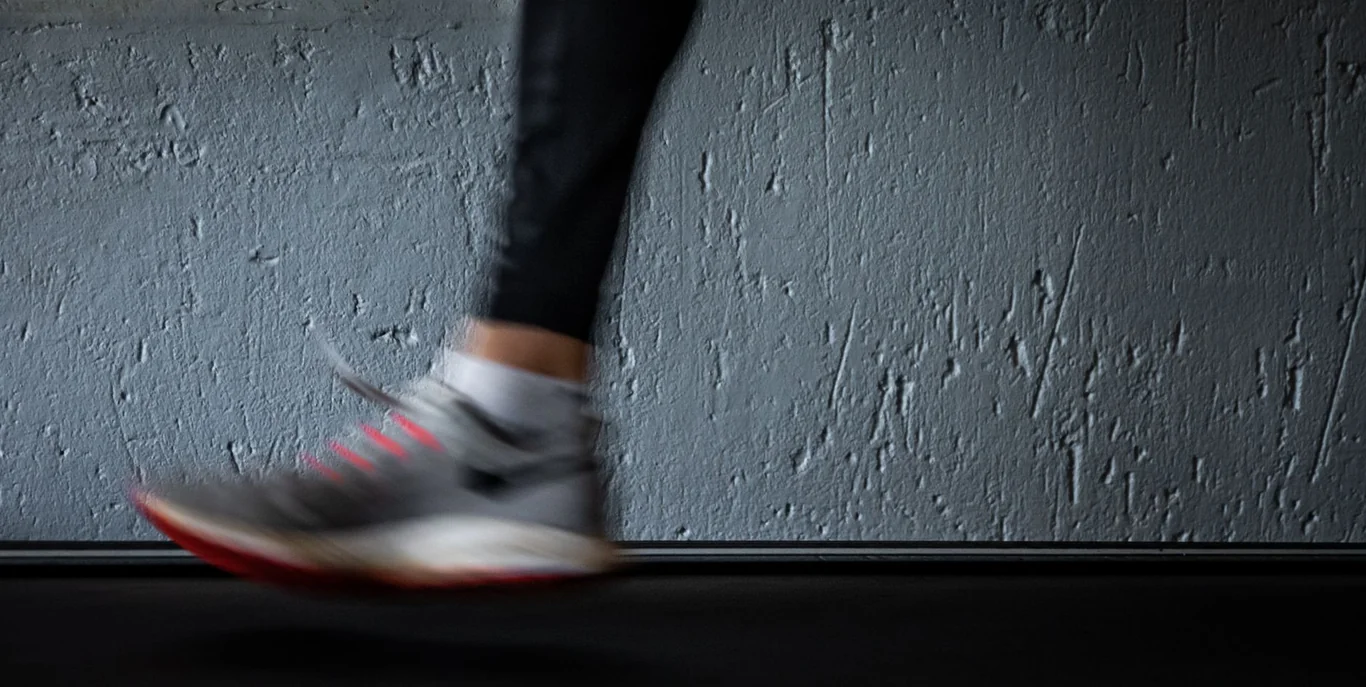 Close-up of a runner's shoe mid-stride on a treadmill belt