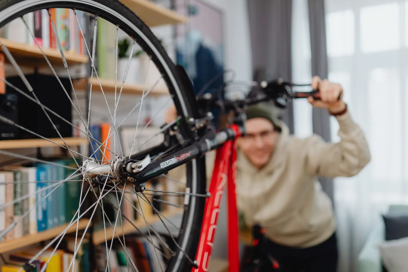 Person adjusting a road bike handlebar in a home living room