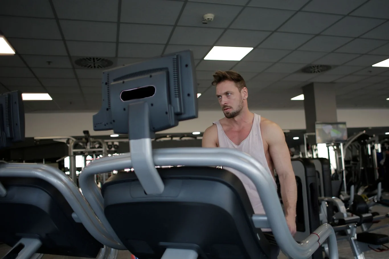 Man using a StairMaster machine at the gym during a cardio workout for weight loss